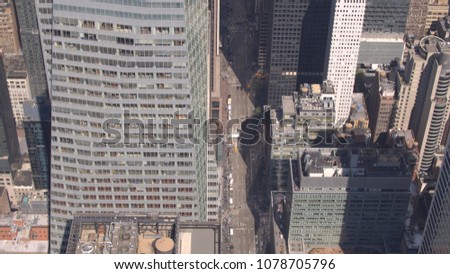 AERIAL CLOSE UP: Flying above glassy skyscrapers along the 6th avenue in midtown New York City. High modern skyscrapers and contemporary condominium apartment buildings in downtown Manhattan