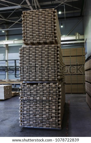 Modern production and storage room with lumber produced and ready for shipment. Storage and production. Industrial photography inside the demonstration production facilities.