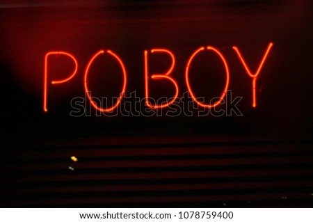 Neon Po Boy Sign in Restaurant Window at Night