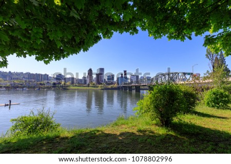 Hawthorne bridge on Willamette river with cityscape and skyline in portland