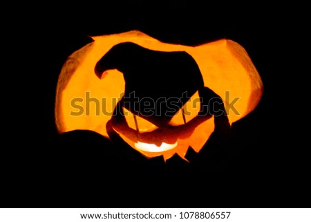 Scary illuminated halloween pumpkin on the dark background