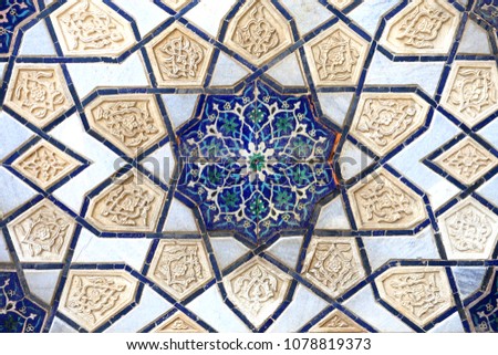Photo background of gorgeous macro Uzbek oriental ornament on the wall