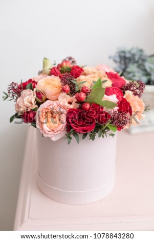 Multicolor bouquet of beautiful flowers on wooden table. Floristry concept. Spring colors. the work of the florist at a flower shop. Vertical photo