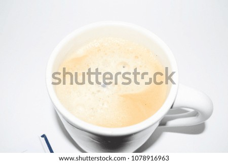 Photo of a cup of coffee on the desktop. Coffee break while working.
