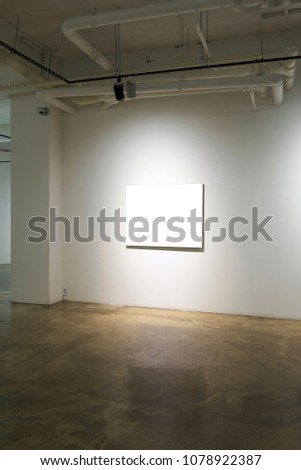 Gallery Interior with empty canvas on wall.