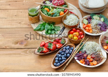 Buddha Bowl Meal Preparation, ingredients in bamboo plates, green matcha tea, pomergranate juice, Satay Sauce with Chia seeds, Healthy food, Clean eating, superfood, detox, balance diet concept 