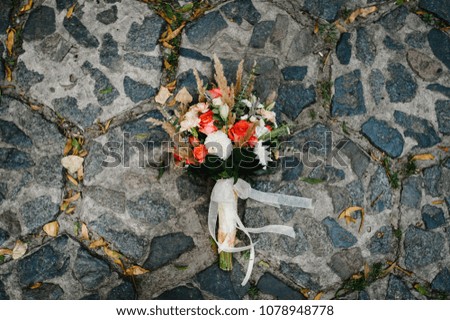 Colorful stylish wedding bouquet made of flowers lies on the pavement. Bouquet of the bride in the street. Nobody. Top view.