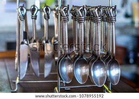 hang many spoons on table