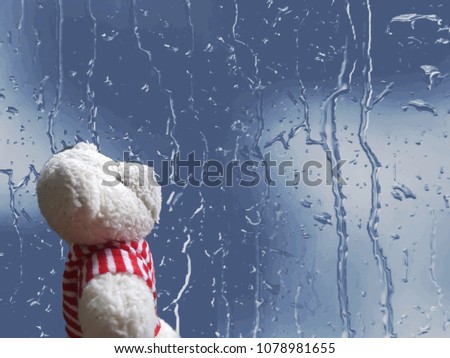 Lonely white Teddy Bear sitting and looking out at the window in rainy day with copy space.