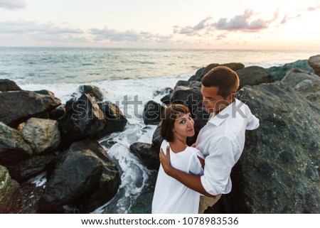 loving couple at the sea at sunset