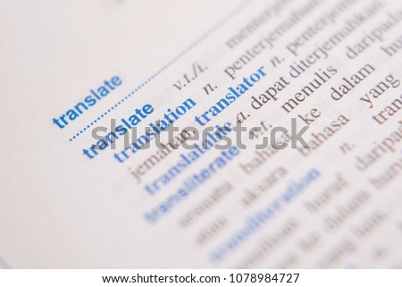 close up of a TRANSLATE word in a dictionary. english to malay dictionary. translator and language concept Royalty-Free Stock Photo #1078984727