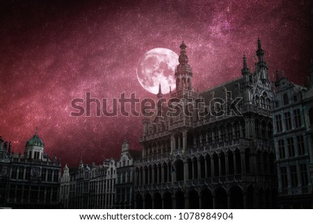Grand Place - the historic square in the center of Brussels.The stars and the moon shine at night.