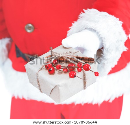 Real Santa Claus holding christmas gifts, isolated on white background.
