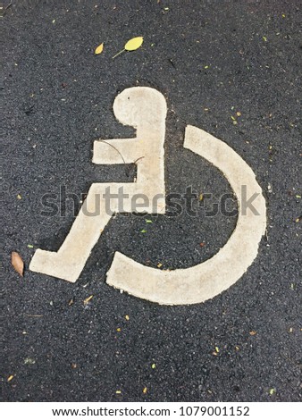 Wheel chair sign on a road in the public Park