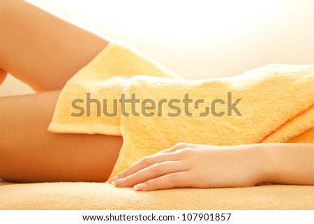 closeup picture of female hands and legs in spa salon