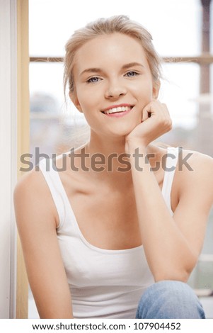 picture of happy teenage girl at the window