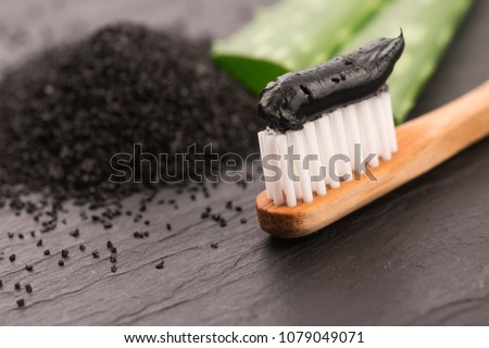 Toothbrush with black charcoal toothpaste with aloe vera Royalty-Free Stock Photo #1079049071