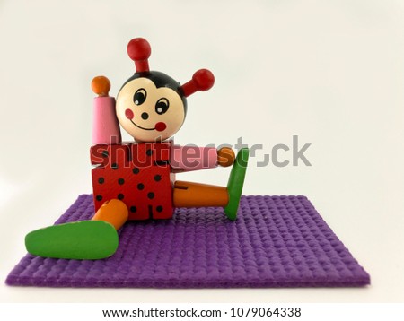 Figurine of ladybug on the rug for yoga