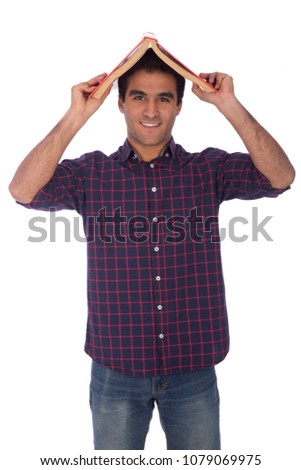 Handsome young man wearing classic out, holding his book on his head to protect himself from rain, isolated on white background.