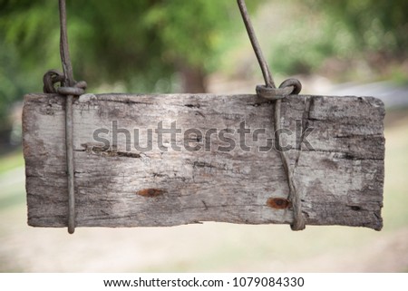 wood sign hanging on rope in tree