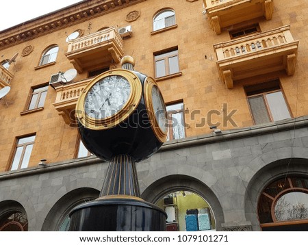 Street clock on orange building background