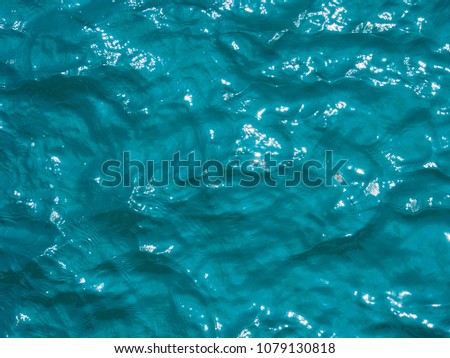 Top view of blue ocean water soft wave, With glitter sunlight. Background pattern