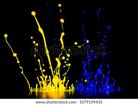 splash of acrylic paint, multicolored paints explosion, blue-yellow abstract background on black