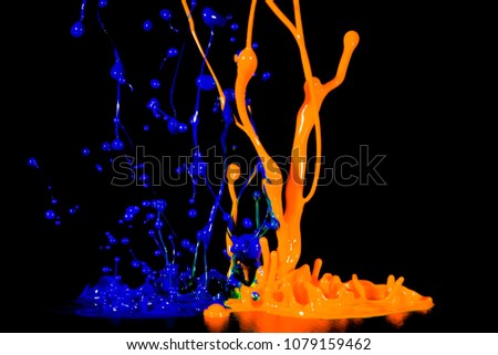 splash of acrylic paint, multicolored paints explosion, blue-orange abstract background on black