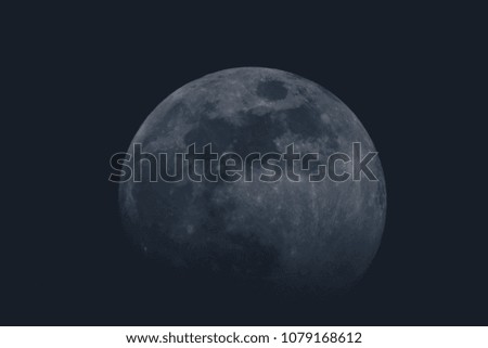 Full moon over dark background sky. Closeup of a moon on the sky, with slight fade to black on the bottom. Round shape of a moon on black sky.