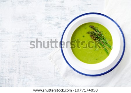 Cream of Green Asparagus and Broccoli Soup with Herbs. Flatlay. Copy space