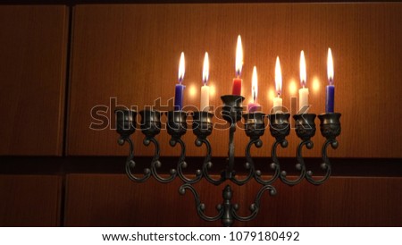 Seven candles in hanukkiah are burning on the sixth day of the Jewish holiday Hanukkah on wooden texture background. Selective focus. 4k
