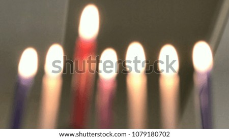 Seven candles in hanukkiah are burning on the sixth day of the Jewish holiday Hanukkah. Blurred view. 4k