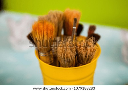 Brushes in a yellow metallic glass