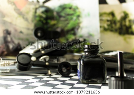 Chinese ink container and drawing tools, in an abstract background of geometric figures in black and white