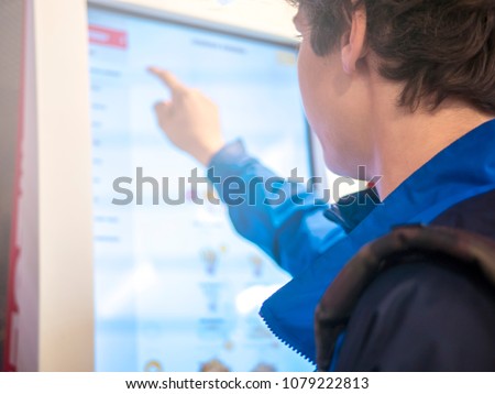 young man using huge touch screen panel close up portrait
