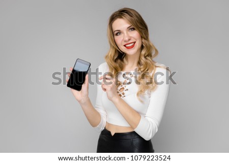 Young woman presenting telephone