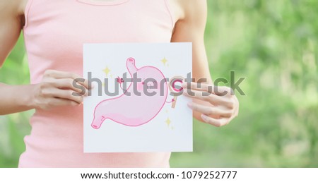 woman take health stomach billboard with green background