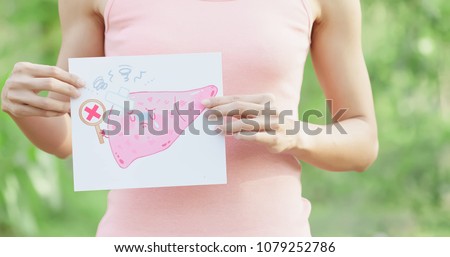 woman take liver billboard with health concept with green background