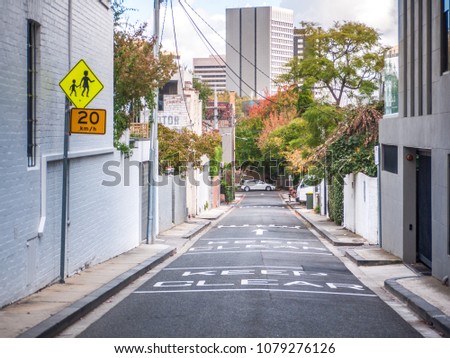 Laneway between suburban houses with speed limit sign on side. South Yarra, VIC Australia.