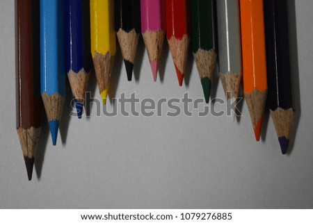 Stock Photo - Collection of colored pencils in a row


