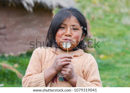 Little native american girl blowing dandelion flower. Royalty-Free Stock Photo #1079319041