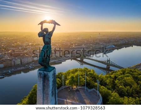 Budapest, Hungary - Aerial view of the beautiful Hungarian Statue of Liberty with Liberty Bridge and skyline of Budapest at sunrise with clear blue sky Royalty-Free Stock Photo #1079328563