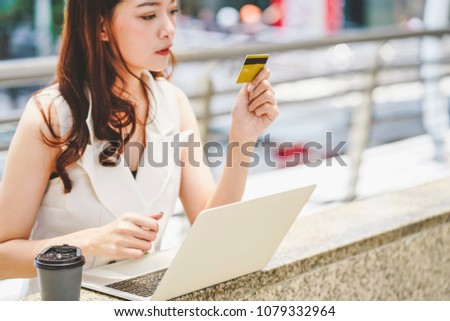 Focus credit card and notebook beautiful asian woman joyful happy shopping with laptop.