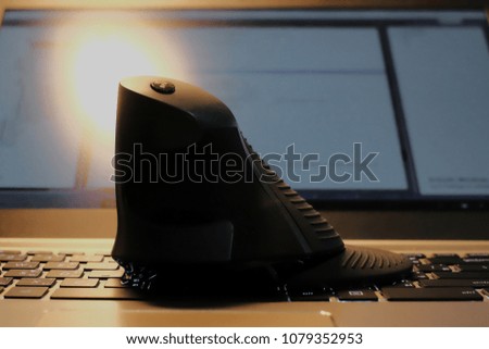  a vertical mouse over keyboard of notebook