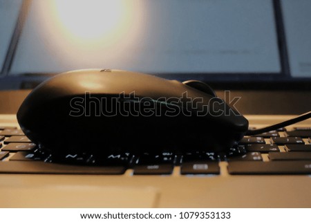  a mouse over keyboard of notebook