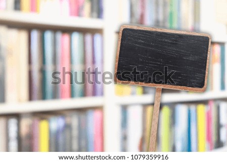 Blank blackboard label and blurred library in the background. 