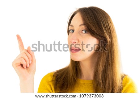 Woman pointing her finger upwards. Free space for text
