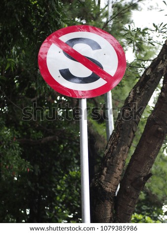 do not stop sign signage with various plants and trees on the background in Jakarta Indonesia 