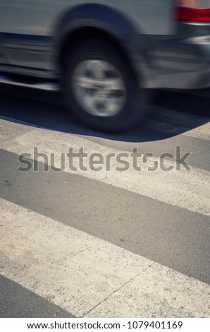 Fast car on a pedestrian crossing. 