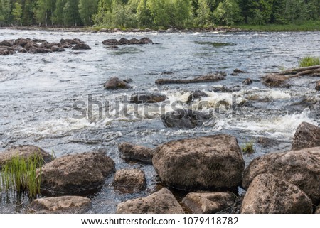 Landscape with river, rapids, rocks and forest 